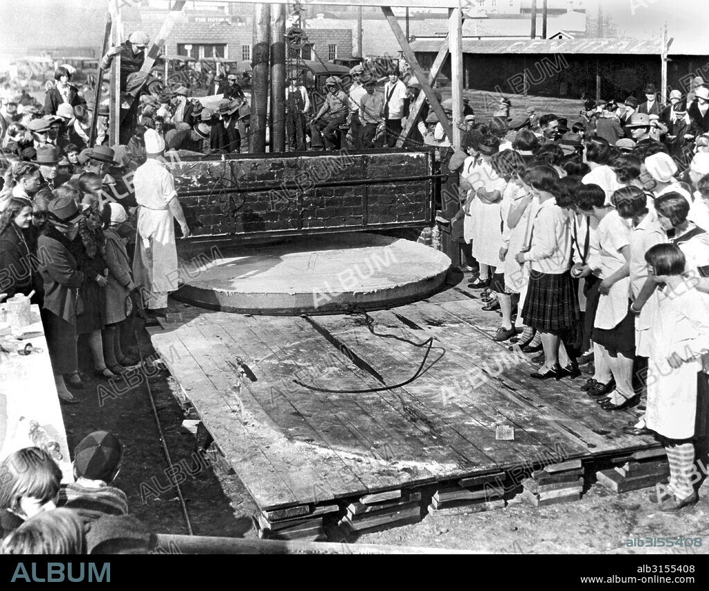 Yakima, Washington:   October, 1927. Bakers preparing to bake  the world's largest apple pie to celebrate National Apple Week in Yakima. The pie is 10 feet across, has 400 gallons of apples, and it took five cords of wood to heat the oven to bake it. It weighs 1 ton, and was consumed by 2000 school children.