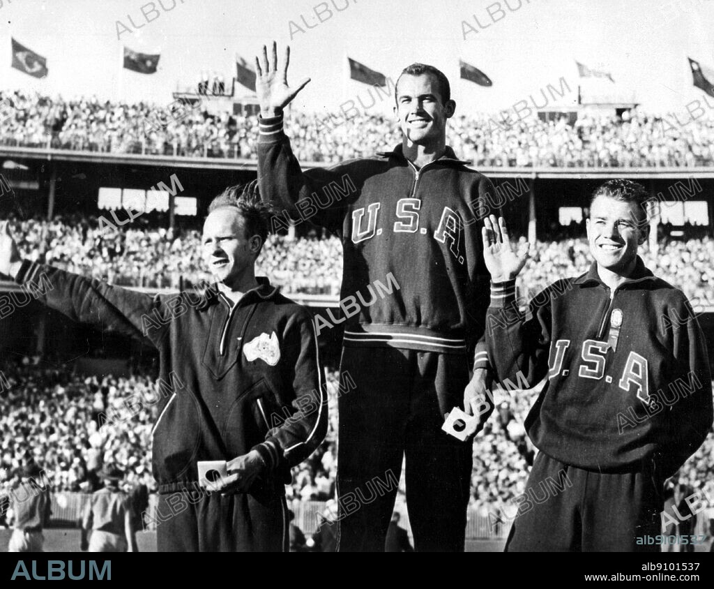 Aus., Melbourne, Olympics, 1956: Men's 100 metres winners' podium. l-r: 3rd, Hec Hogan ; 1st, Bob Marrow ; 2nd Walter Baker.