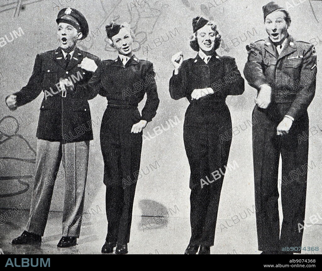 Photograph of Bing Crosby, Vera-Ellen, Rosemary Clooney, and Danny Kaye performing a number from 'White Christmas'.