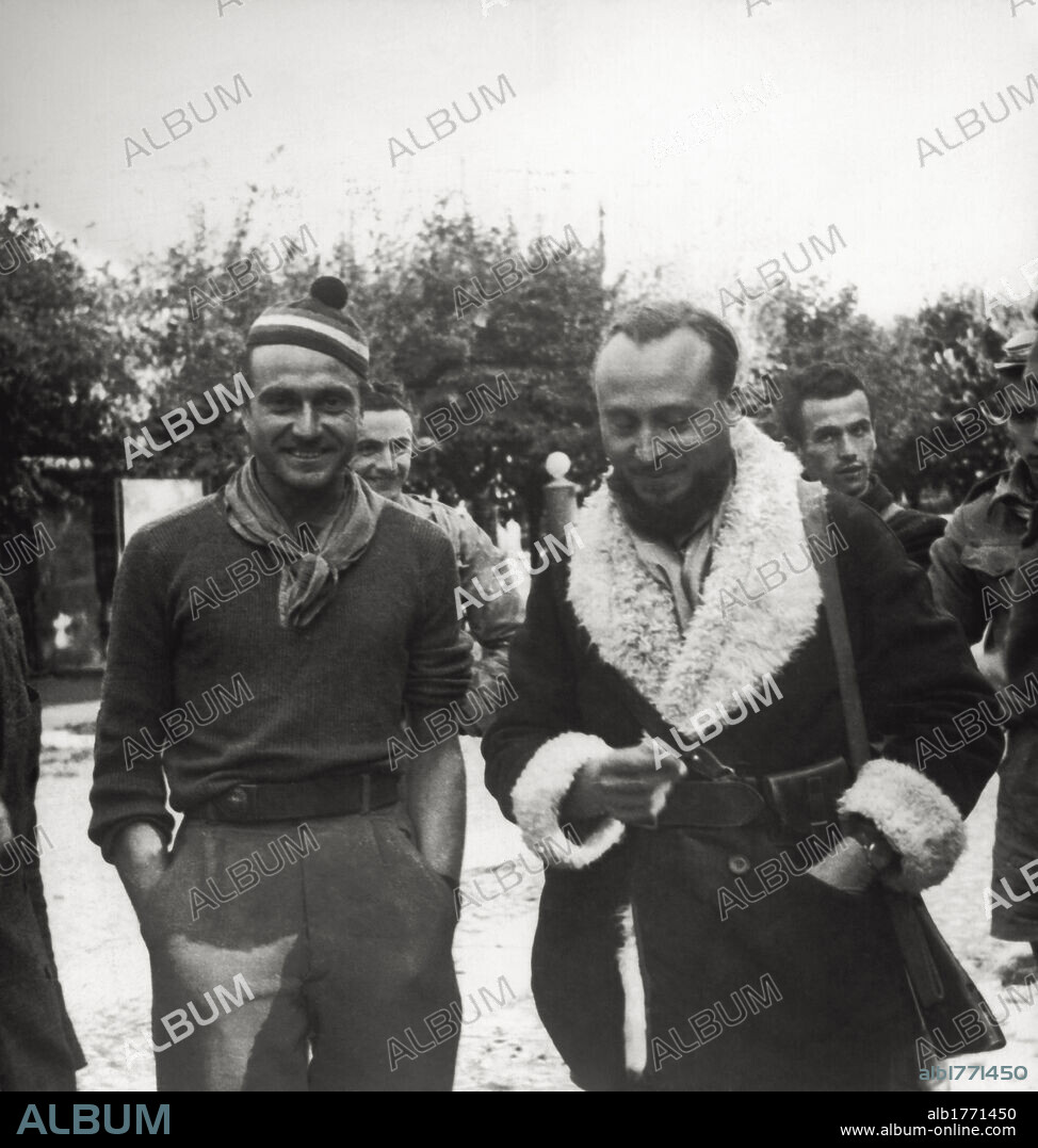 Enrico Martini "Mauri". Commander Enrico Martini, also known by his nom de guerre "Mauri", is walking with his partisans, during the occupation of the city. Alba, 1944.