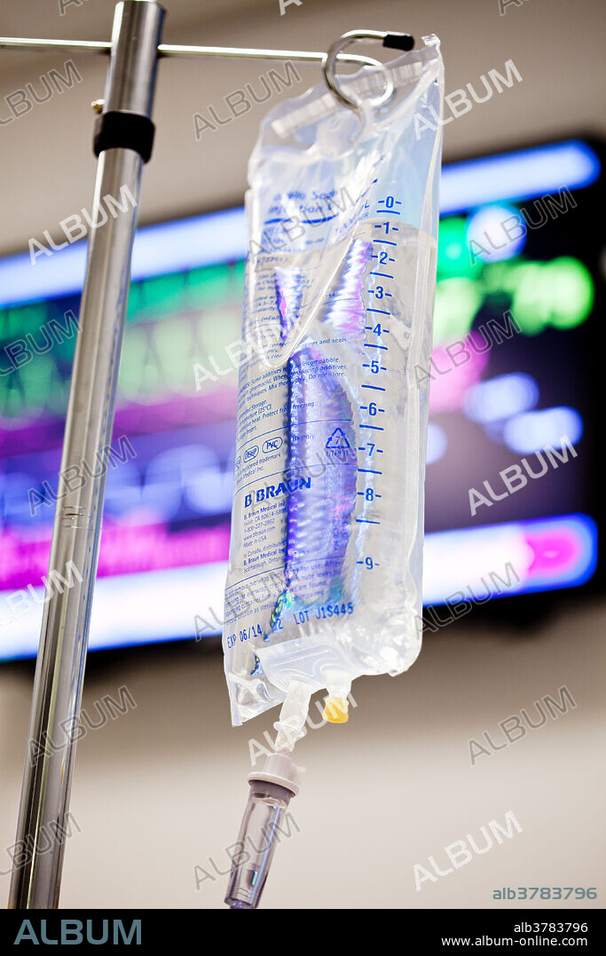 An intravenous (IV) drip bag containing 0. 9% sodium chloride (saline). The tube at left carries the drug into the bloodstream, usually through veins in the forearm. An intravenous infusion, or drip, may also be used to give blood and plasma or to maintain the level of body fluids in patients who cannot eat or drink. The rate at which the solution containing the drug enters the circulation is controlled by an adjustable valve.