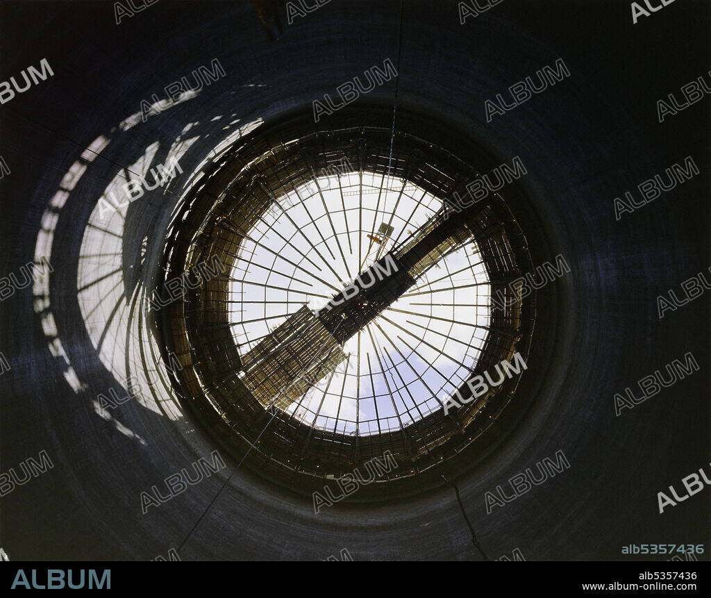 JOHN LAING PLC. A view looking upwards from the inside of a sugar silo towards the roof structure and conveyor bridge during its construction at Bury St Edmunds Sugar Beet Factory. A sugar factory began operating at Bury St Edmunds in 1924. In 1972 Laing announced they would be building four sugar silos and a new beet handling plant for the British Sugar Corporation at Bury St Edmunds, and in 1981/82 a further 25,000 tonne capacity sugar silo was built.