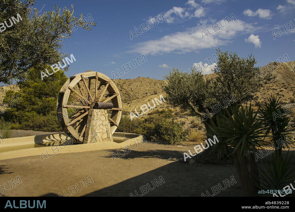 Province of Almería, Andalusia, Spain, Europe. Tabernas Desert (Desierto de Tabernas). Mini Hollywood film set, western theme park. Far West town. Wheel for water mill.