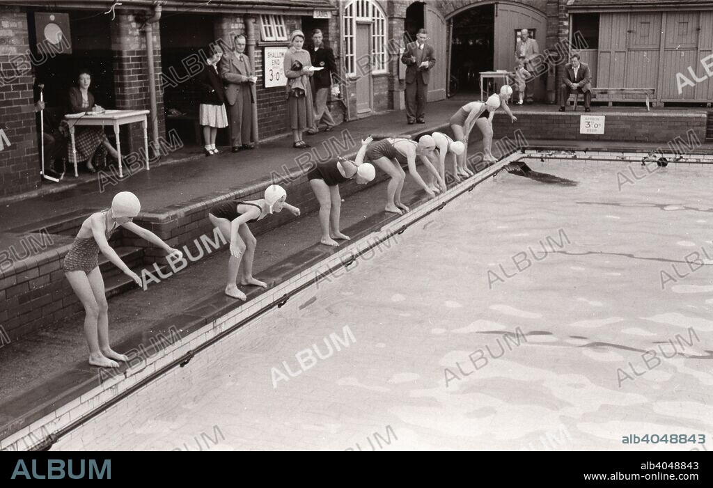 Girls line up for a swimming race, Yearsley Baths, York, Yorkshire, 1956.