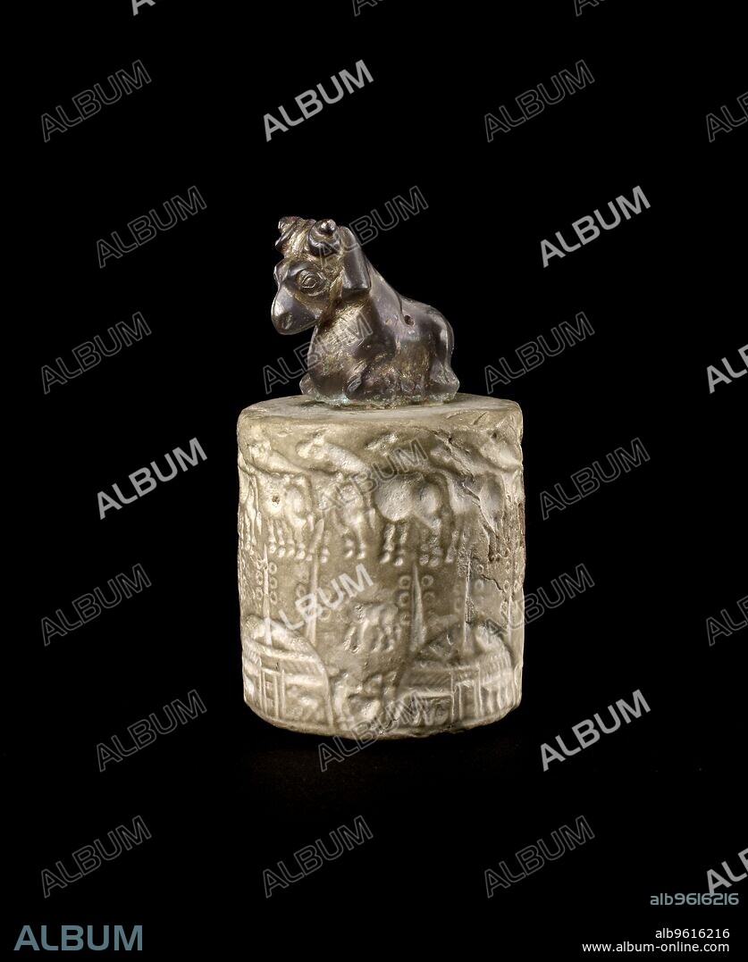 Seal, Late Uruk period, 4000 to 3100 BC. Handled cylinder seal (Milking Seal) with a scene of pastoral wealth in the marshes of souther Iraq; upper scene: herd of cattle; middle scene: four calves passant; lower scene: four reed huts with ring pole standards, between each hut a calf is represent. Dimension: height: 5.3 cm seal sectiondiameter: 4.6 cm seal sectionlength: 2.5 cm the ramheight: 3.5 cm the ram.