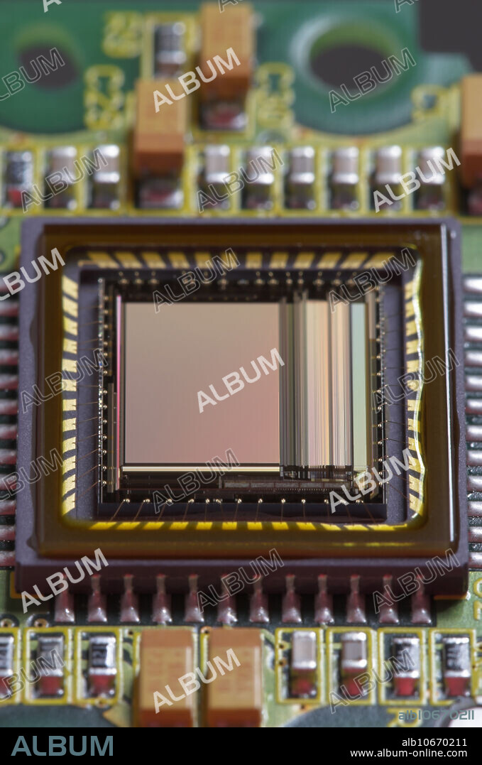 Shown here is the CMOS sensor manufactured by Micron Technology (MT9V403) mounted on a printed circuit board. The assembly is used in the Basler A601f monochrome digital video camera designed for industrial/OEM applications. The sensor has 656 x 491 pixels (VGA resolution), with individual pixel dimensions of 9.9 x 9.9 micron. Aug 2007.
