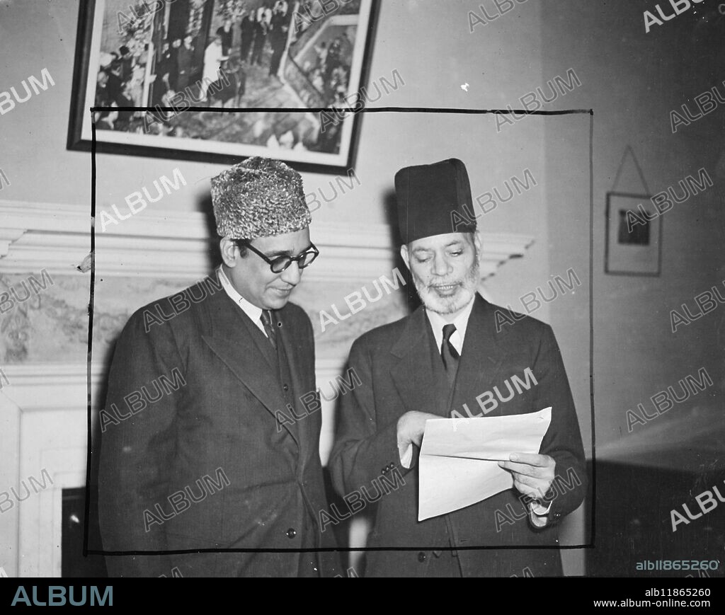 Sir Muhammad Zafarullah Khan, Foreign Minister to the Pakistan Government and leader of his country's delegation to U.N.O., left London for New York by air today. He will present Pakistan's case to the Security Council in regards to the Kashmir dispute. Picture shows: Sir Muhammad Zafarullah (right) Khan discusses points of Pakistan's case tub H.E. Habib Ibrahim Rahimtoola, the Pakistan High Commisioner, pictured at the office of the High Commissioner for Pakistan in London. 12 January 1948.