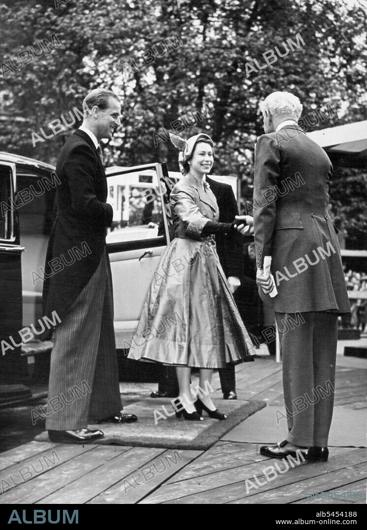 The Queen is greeted by the Lord Great Chamberlain, the Marquis of Cholmondeley, as she arrives with the Duke of Edinburgh at Westminster hall yesterday. She was attending a lunch given in her honour by the Commonwealth Parliamentary Association. Crowds cheered as the royal couple appeared and the heavy rain stopped. June 10, 1953. (Photo by Daily Mirror).
