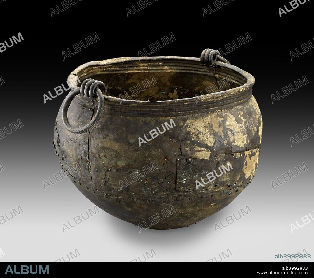 Bronze cauldron, Late Bronze Age (Britain), (c1100 BC-1000 BC). Bronze cauldron made of three hammered sheets rivetted together and with cast handles; repaired in antiquity. Dimensions: height: 43 cm (without lugs)height: 46.5 cm (with lugs)diameter: 53 cm (max).
