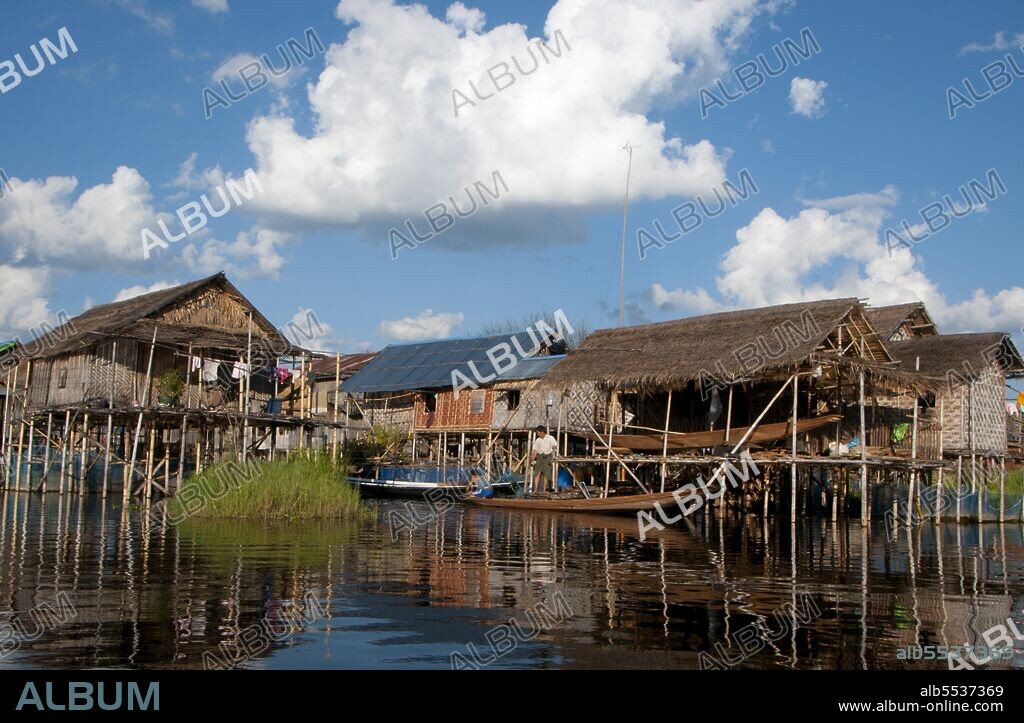 Inle Lake is a freshwater lake located in the Nyaungshwe Township of Taunggyi District of Shan State, part of Shan Hills in Myanmar (Burma). It is the second largest lake in Myanmar with an estimated surface area of 44.9 square miles (116 km2), and one of the highest at an altitude of 2,900 feet (880 m). The people of Inle Lake (called Intha), some 70,000 of them, live in four cities bordering the lake, in numerous small villages along the lake's shores, and on the lake itself. The entire lake area is in Nyaung Shwe township. The population consists predominantly of Intha, with a mix of other Shan, Taungyo, Pa-O (Taungthu), Danu, Kayah, Danaw and Bamar ethnicities. Most are devout Buddhists, and live in simple houses of wood and woven bamboo on stilts; they are largely self-sufficient farmers. Most transportation on the lake is traditionally by small boats, or by somewhat larger boats fitted with single cylinder inboard diesel engines. Local fishermen are known for practicing a distinctive rowing style which involves standing at the stern on one leg and wrapping the other leg around the oar. This unique style evolved for the reason that the lake is covered by reeds and floating plants making it difficult to see above them while sitting. Standing provides the rower with a view beyond the reeds. However, the leg rowing style is only practiced by the men. Women row in the customary style, using the oar with their hands, sitting cross legged at the stern. The Inle lake area is renowned for its weaving industry. The Shan-bags, used daily by many Burmese as a tote-bag, are produced in large quantities here. Silk-weaving is another very important industry, producing high-quality hand-woven silk fabrics of distinctive design called Inle longyi. A unique fabric from the lotus plant fibers is produced only at Inle lake and is used for weaving special robes for Buddha images called kya thingahn or 'lotus robe'.