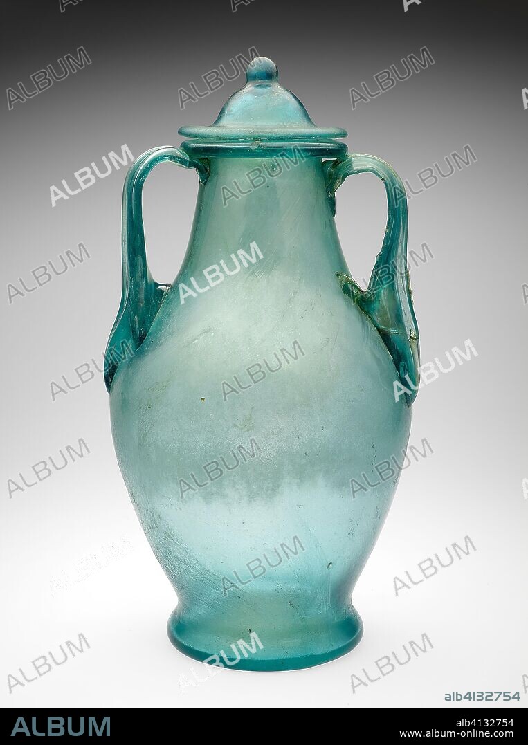 ANCIENT ROMAN. Urn. Roman. Date: 50 AD-200 AD. Dimensions: a (urn): 33.3 × 19 × 19 cm (13 1/8 × 7 1/5 × 7 1/5 in)
b (lid): 30.4 ×  10.1 × 10 cm (12 × 4 × 3.96 in). Glass, blown technique. Origin: Roman Empire.