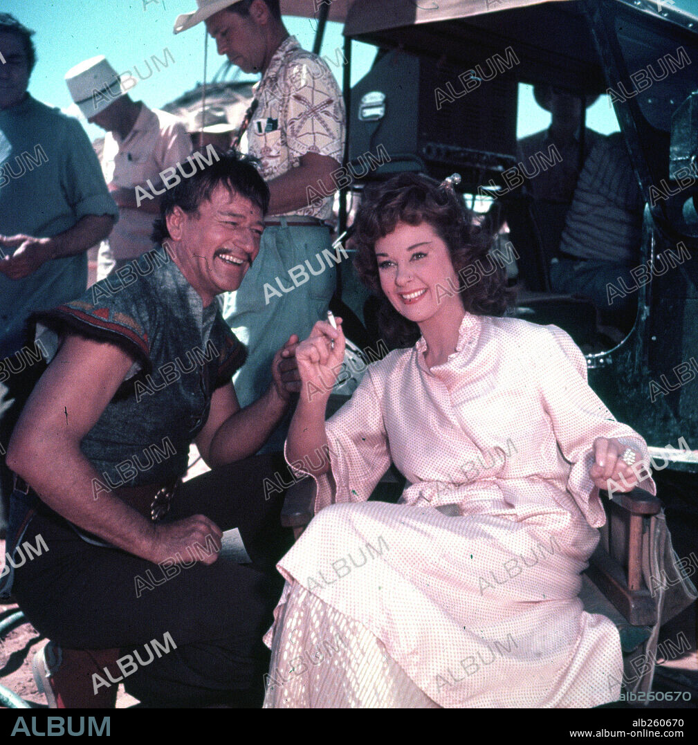 JOHN WAYNE and SUSAN HAYWARD in THE CONQUEROR, 1956, directed by DICK POWELL. Copyright RKO.