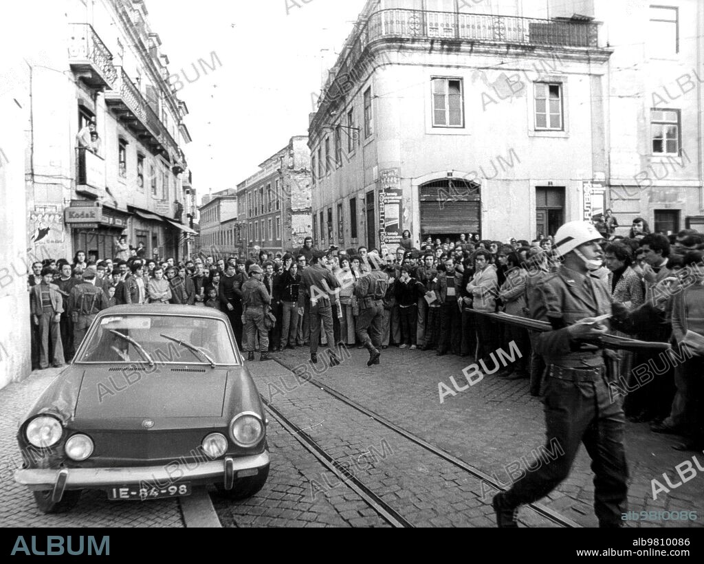 Lisboa (Portugal), 26/04/1974. El automóvil ""Fiat 850" es acordonado por la Policía militar: en su interior, dos supuestos agentes perseguidos.