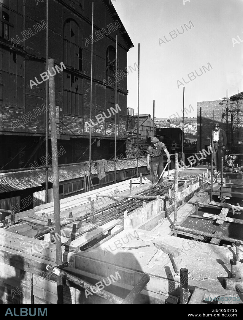 Modernisation of the South Yorkshire coalfields, Cadeby Colliery, near Doncaster, 1955. Civil engineers make preparations for a concrete pour on the site of the new heapstead at Cadeby Colliery. The pit sat under the shadow of Conisborough Castle and after it closed in the 1980s became the location of the ill-fated and ill-planned Earth Centre. After swallowing millions of pounds of lottery cash the ecological park closed after a year.