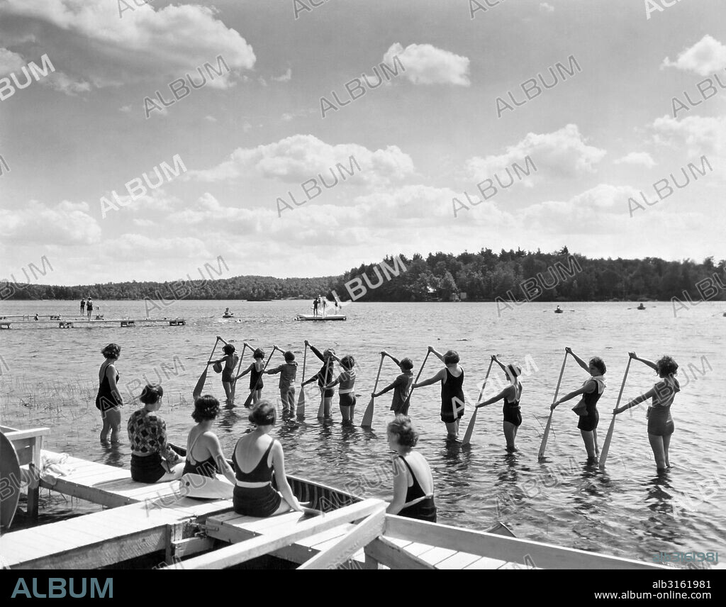 East Otis, Massachusetts:  c. 1926. Girl campers learning how to handle a canoe paddle on Big Pond Lake at the Bonnie Brae Girl Scout Camp.