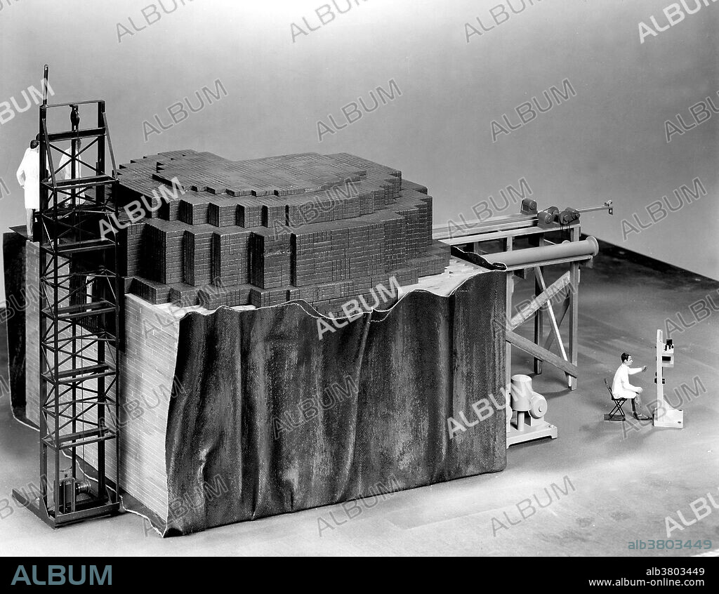 Closeup of scale model (1/2 in. = 1 ft.) of CP-1 reactor temporarily removed from its West Stands racquets court environment. Chicago Pile-1 (CP-1) was the world's first artificial nuclear reactor. The construction of CP-1 was part of the Manhattan Project, and was carried out by the Metallurgical Laboratory at the University of Chicago. It was built under the west viewing stands of the original Stagg Field. The first man-made self-sustaining nuclear chain reaction was initiated in CP-1 on December 2, 1942, under the supervision of Enrico Fermi. Fermi described the apparatus as "a crude pile of black bricks and wooden timbers." It was made of a large amount of graphite and uranium, with "control rods" of cadmium, indium, and silver, and unlike most subsequent reactors, it had no radiation shield or cooling system. Upon completion of the experiment, a coded message was transmitted to President Roosevelt: "The Italian navigator has landed in the new world.".