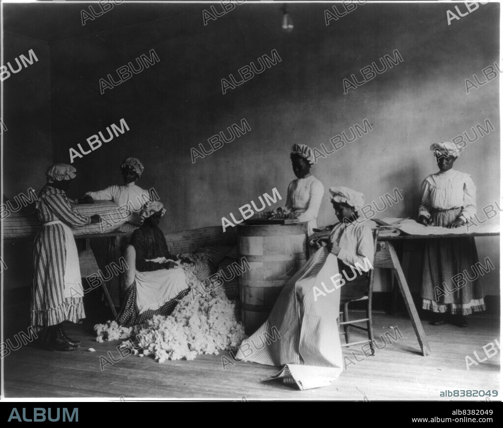 FRANCES BENJAMIN JOHNSTON. African American students in mattress-making class, Tuskegee Institute, Tuskegee, Ala., 1902. [Young women learning upholstery and soft furnishing].