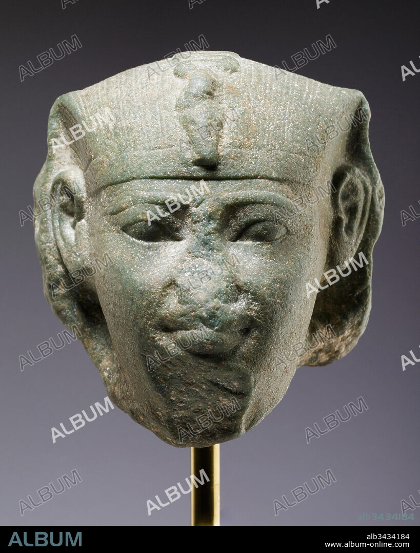 Head of a sphinx, possibly of Amenemhat I, Middle Kingdom, Dynasty 12, ca. 1981–1952 B.C., From Levant; Possibly from Tyre, Dolomitic marble, H. 14.1 cm (5 9/16 in.), The smiling mouth, wide open eyes, and rounded cheeks suggest a youthful king, and the proportions of the nemes, along with the depth of the break, indicate that the head was part of a comparatively small sphinx.