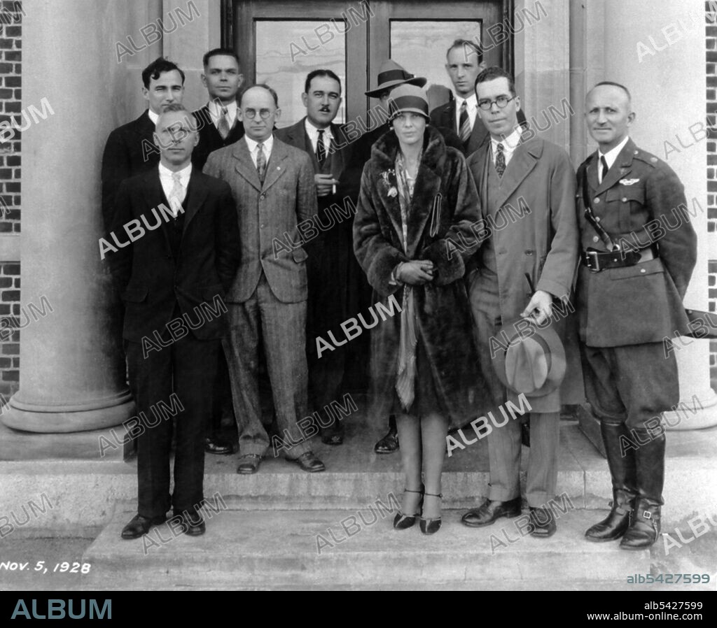 Amelia Earhart visits NACA, Virginia, USA, Nov. 5, 1928. American pioneer aviator Earhart on the steps of the Langley Research Building, National Advisory Committee for Aeronautics. Front row L-R: E.A. Meyers, Elton Miller, Amelia Earhart, Henry Reid, and Lt. Col. Jacob W.S. Wuest. Back row: Carlton Kemper, Raymond Sharp, Thomas Carroll, (unknown person behind A.E.), and Fred Weick.
