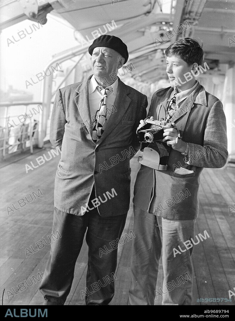 Famed sculptor Jacob Epstein , and his 15-year-old son Jackie take a look at England on their arrival in Southampton on board the liner New Amsterdam from New York . 22 August 1949.