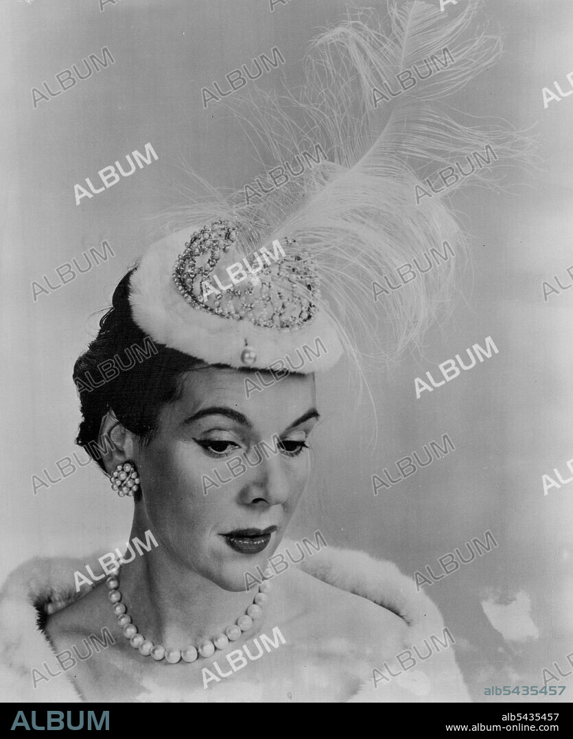 "Mrs Cornelius Vanderbilt Whitney Wears Mr. John's Coronation Chapeau" - "Mrs Cornelius Vanderbilt Whitney famous beauty of American society is shown wearing Mr. John's exciting treasure trove tiara from his "Coronation of Spring 1953 Spring and Summer Collection. This "Crown Jewel" is appropriately called, "Royal Treasure" and features an exquisite diamond coronet with a commanding drift of Royal Aigrette on an inner cap of regal ermine. Mr. John long recognized as King of the Hat world, predic.