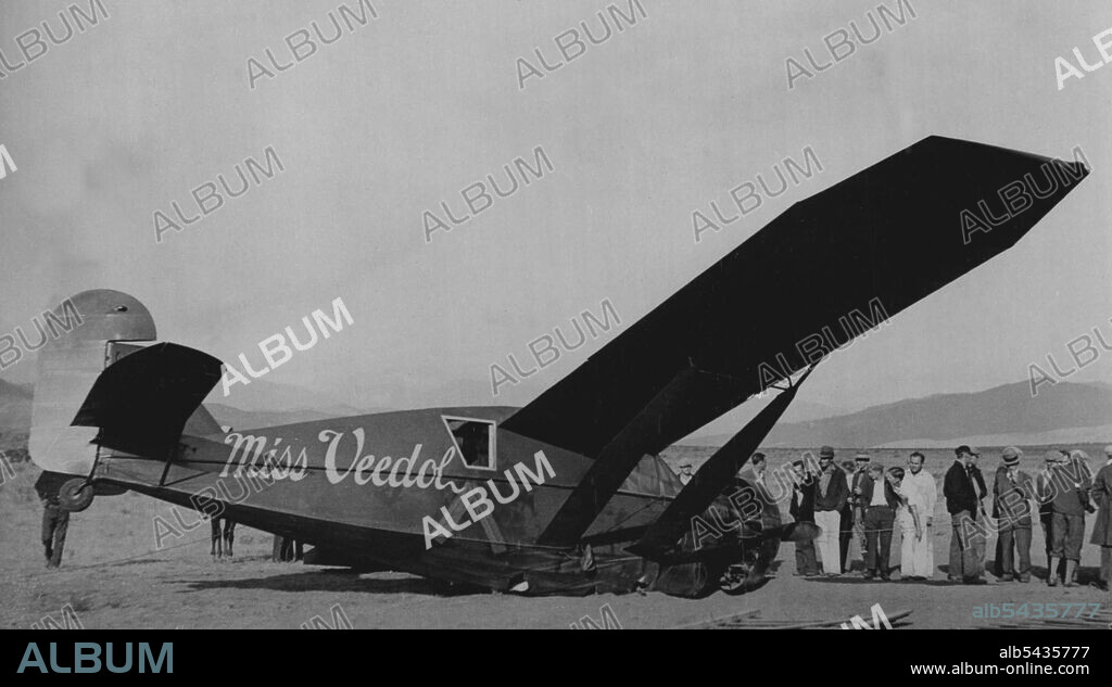 Finish Of First Pacific Flight -- The airplane after it had landed at Wenatchee. The airplane "Miss Veedol" piloted by Clyde Pangborn and Hugh Herndon Jr., photographed just after it had landed at Wenatchee, Washington, after completing the first non-stop flight from Japan to America. They shed their landing gear shortly after leaving Japan, to lighten their load, which made the landing at their destination a very precarious one. December 16, 1931. (Photo by Daily Mirror).