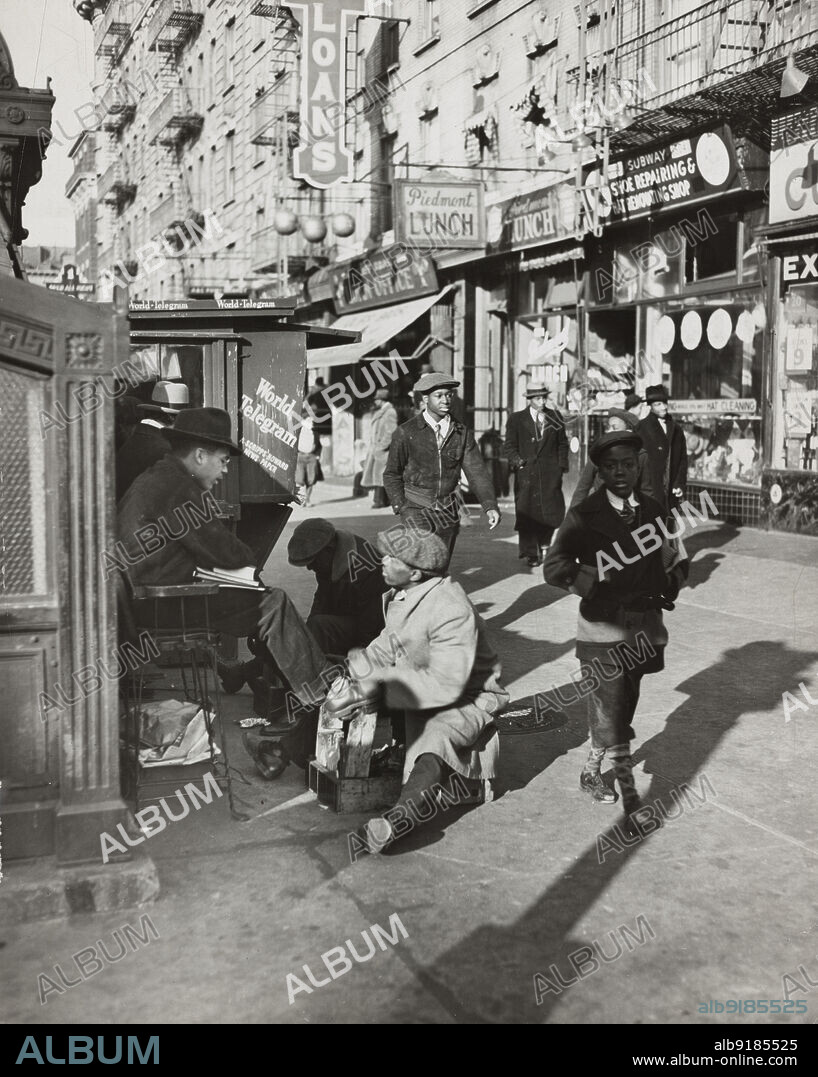 View of Lenox Avenue, Harlem, at 135th Street, showing businesses, pedestrians and shoe-shine stand, March 23, 1939.