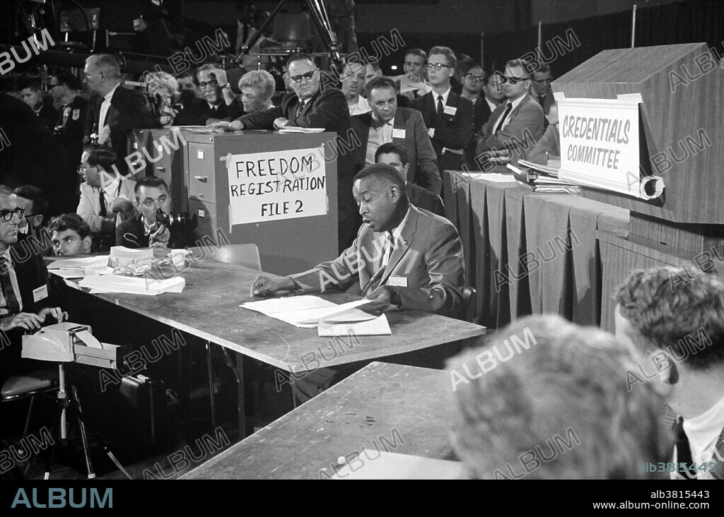 Entitled: "Aaron Henry, chair of the Mississippi Freedom Democratic Party delegation, speaks before the Credentials Committee at the Democratic National Convention, Atlantic City, New Jersey." The Mississippi Freedom Democratic Party (MFDP) was an American political party created in the state of Mississippi in 1964, during the civil rights movement. It was organized by African Americans from Mississippi, with assistance from the Student Nonviolent Coordinating Committee (SNCC) and Council of Federated Organizations (COFO), to challenge the legitimacy of the then-white-only Mississippi Democratic Party. The MFDP sent its elected delegates by bus to the Democratic National Convention in New Jersey. There they challenged the right of the Mississippi Democratic Party's delegation to participate in the convention, claiming that the regulars had been illegally elected in a completely segregated process that violated both party regulations and federal law, and that furthermore the regulars had no intention of supporting Lyndon B. Johnson, the party's presidential candidate, in the November election. Aaron Henry (July 2, 1922 - May 19, 1997) was an American civil rights leader, politician, head of the Mississippi branch of the NAACP, and one of the founders of the Mississippi Freedom Democratic Party. Photographed by Warren K. Leffler, August, 1964.