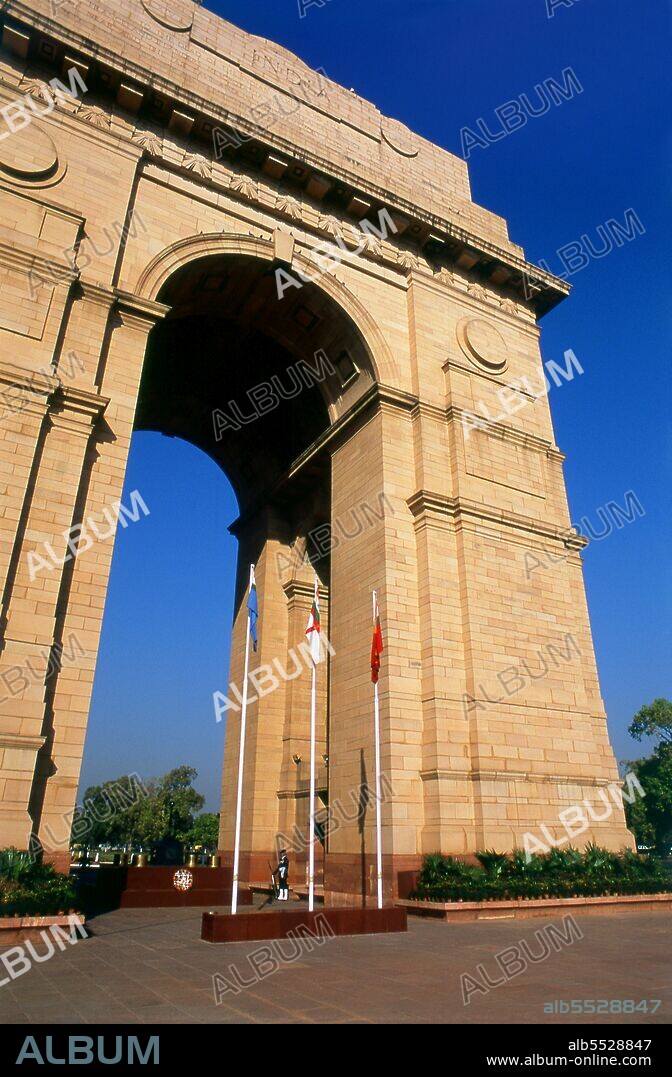 The India Gate, originally called the All India War Memorial, is a war memorial located astride the Rajpath, on the eastern edge of the ‘ceremonial axis’ of New Delhi, formerly called Kingsway. The names of some 70,000 Indian soldiers who died in World War I, in France and Flanders, Mesopotamia, and Persia, East Africa, Gallipoli and elsewhere in the near and the far-east, between 1914–19, are inscribed on the memorial arch. In addition, the war memorial bears the names of some 12,516 Indian soldiers who died while serving in India or the North-west Frontier and during the Third Afghan War. The India Gate war memorial, the architectural style of which has been compared with the Gateway of India in Bombay, and the Napoleonic Arc de Triomphe in Paris, was designed by Sir Edwin Lutyens.