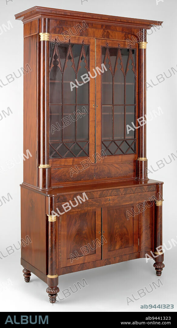 Desk and bookcase, c. 1832-1834, Attributed to Meads and Alvord, Albany, New York, 84 13/16 x 51 x 25 in. (215.42 x 129.54 x 63.5 cm), Mahogany, pine, tulip, brass, glass, United States, 19th century, The business partnership of John Meads (1777-1859) and William Alvord (1766-1853) resulted in some of the most artistically sophisticated furniture made in nineteenth-century America. Meads & Alvord was the premier Neoclassical furniture firm in Albany, and they used their status and shop location to serve a wide clientele throughout the Hudson River Valley and further west along the Erie Canal (completed in 1825). As demonstrated in this desk and bookcase, when designing furniture, Meads & Alvord adopted popular Grecian and Gothic Revival designs that were characteristic of larger American style centers. The overall form of this desk and bookcase was often seen in New York City furniture, while the decoration, such as the carved melon feet, was popular in Boston cabinetwork.