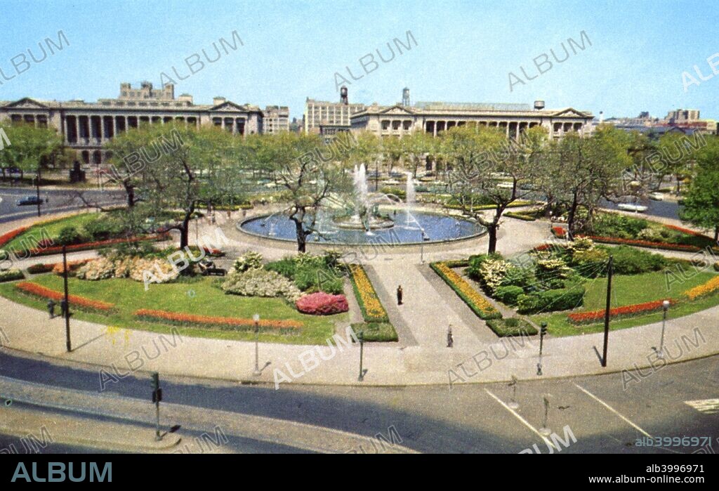 Logan Circle, Philadelphia, Pennsylvania, USA, 1955. Vintage postcard of Logan Circle showing the Free Library of Philadelphia and the Youth Study Center. There is a fountain and pool in the centre of the landscaped circular park.