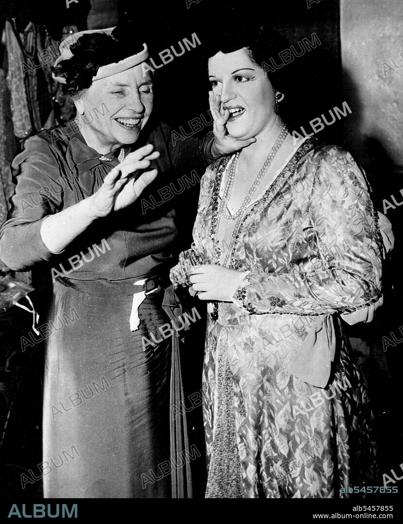 Helen Keller (left), famous blind-deaf author, "Hears" Astrid Varnay rehearsing in a New York Metropolitan house Opera dressing room.Her fingers lightly touching Astrid Varnay's mouth and throat as she rehearses at the New York Metropolitan Opera House,Helen Keller can "hear" the singing from the vibrations. January 28, 1950.