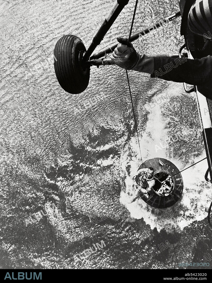 Shepard hoisted from Mercury capsule, 1961. A U.S. Marine helicopter recovery team hoists astronaut Alan B. Shepard Jr. from his Mercury spacecraft after a successful flight and splashdown in the Atlantic Ocean. On May 5th 1961, Shepard became the first American to fly into space. His Freedom 7 Mercury capsule flew a suborbital trajectory lasting 15 minutes 22 seconds. His spacecraft splashed down in the Atlantic Ocean where he and his capsule were recovered by helicopter and transported to the awaiting aircraft carrier U.S.S. Lake Champlain.