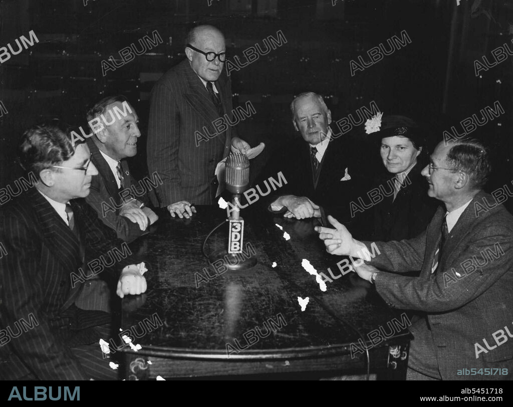 Osborne... Osborne, third from right, looks askance at fellow information-pleaser Crosbie Morrison, as he makes a point.The Information Please braintrusters are (left to right): Alan Nicholls, Eric Welch, compere John Stuart, Professor Osborne, Miss Valentine Leeper and the naturalist, Crosbie Morrison. June 03, 1953.
