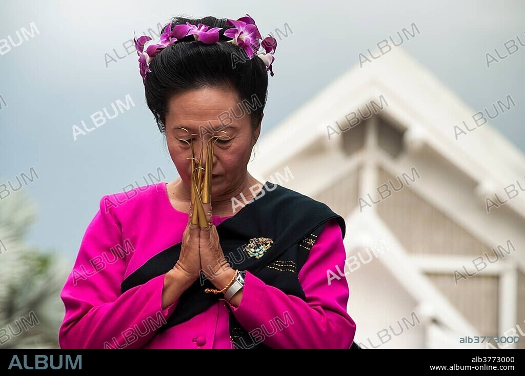Traditional dance, woman wearing traditional clothing making a gesture of greeting or Wai, Loi Krathong or Loy Gratong Festival, Chiang Mai, Northern Thailand, Thailand, Asia.