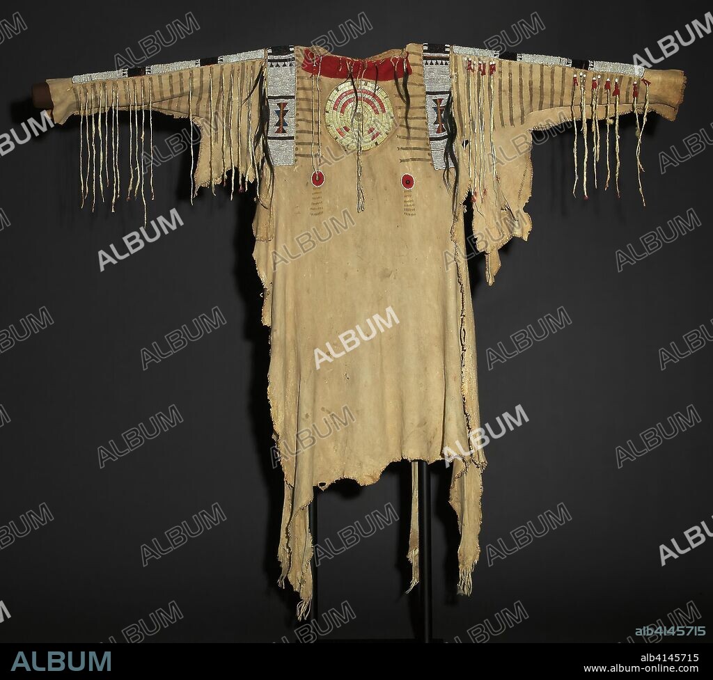 War Shirt. Upper Missouri River Tribe; Missouri, United States. Date: 1830-1840. Dimensions: Appro×. 101.6 × 50.8 cm (40 × 20 in.). Deer hide, ermine tails, glass pony beads, hair, porcupine quills, and trade cloth. Origin: Missouri.