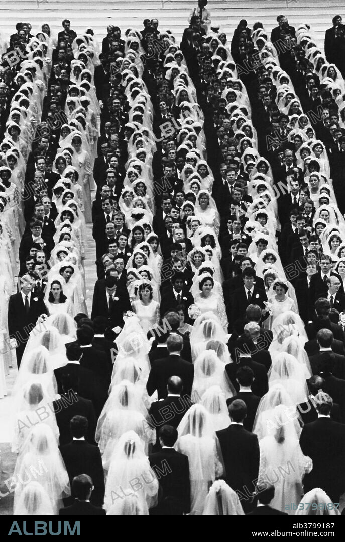 A Moony wedding or "blessing ceremony" at Madison Square Garden, where Reverend Sun Myung Moon spiritually married over 2000 couples in 1982.  Moon (born 1920 in Korea) is the founder of the Unification Church.  He believes that he is the Second Coming of Christ.  He frequently conducts mass spiritual weddings among his followers.