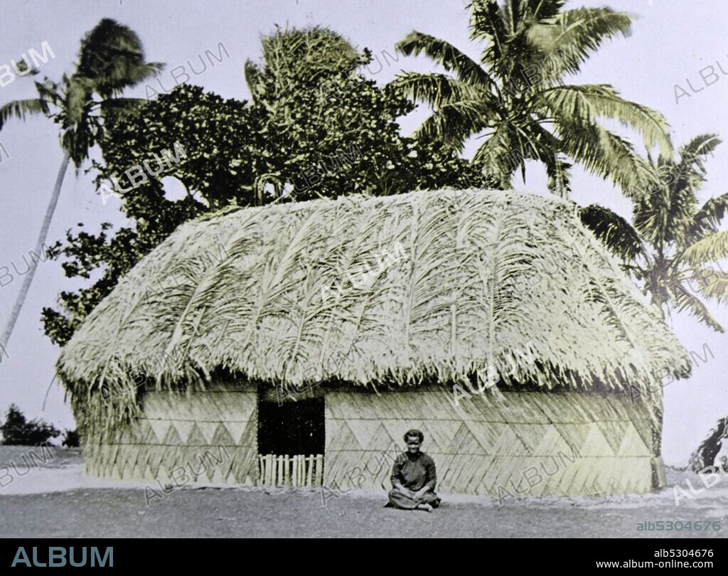 Traditional village home made from coconut leaves and wood; Tonga 1953.