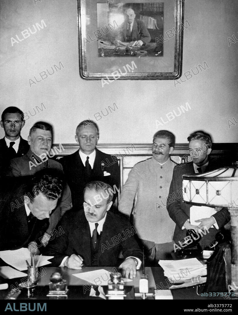 ANONYMOUS. Soviet Foreign Minister Molotov signs the German-Soviet nonaggression pact (Behind: Joachim von Ribbentrop and Joseph Stalin).