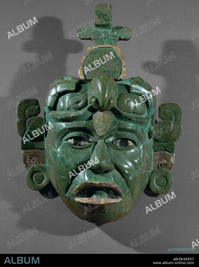 Mosaic mask, a funerary gift from tomb 160, Tikal, El Peten, Guatemala. It was laid over the face of the dead dignitary to adorn him during his voyage through the Underworld. Jadeite, diopsite, shells, conch-shells, mother of pearl (6th). Height 34.5 cm. Inv. 11082.