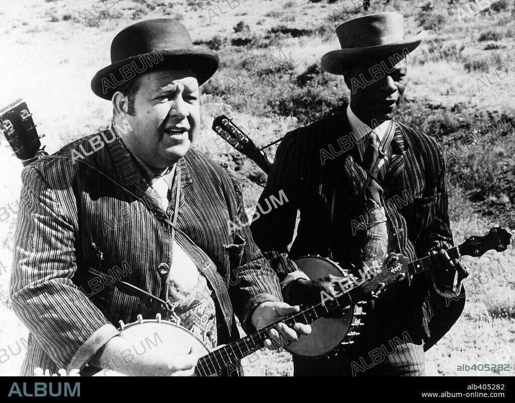 NAT KING COLE and STUBBY KAYE in CAT BALLOU, 1965, directed by ELLIOT SILVERSTEIN. Copyright COLUMBIA PICTURES.