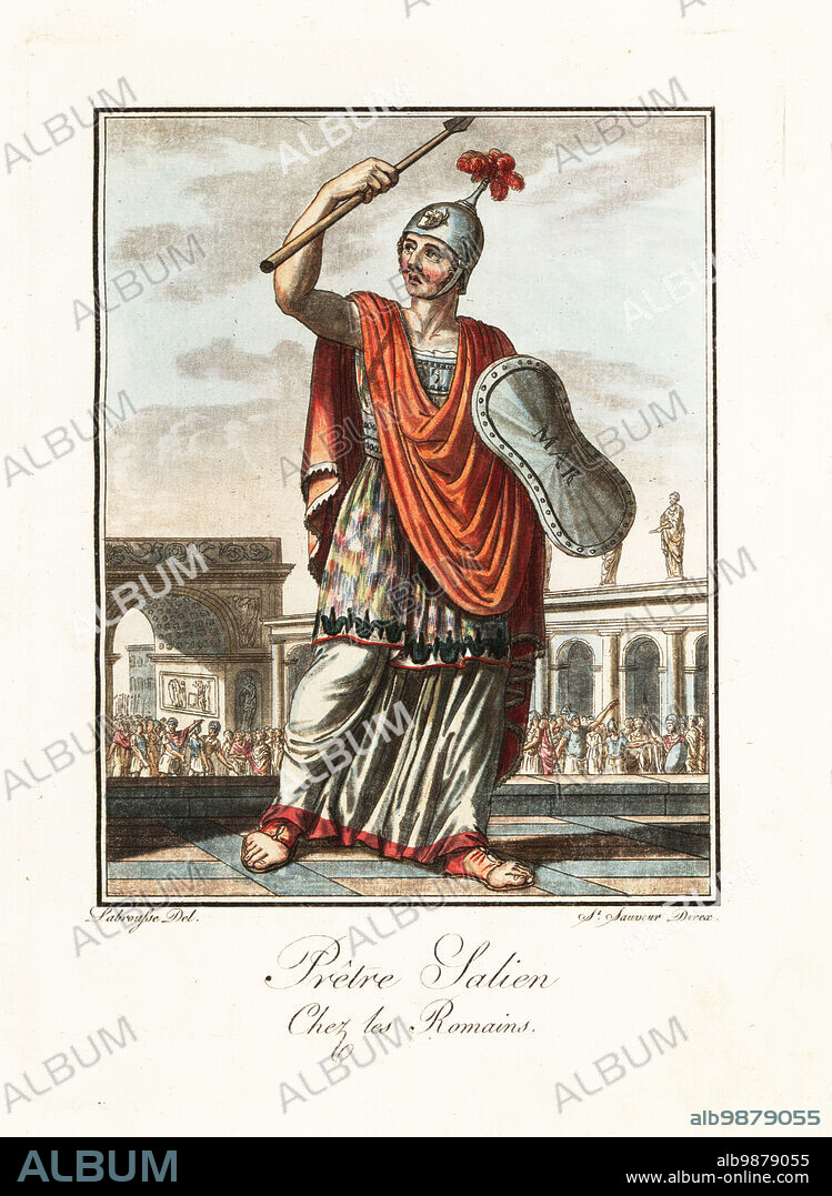 One of the 12 Salii, or leaping priests, in costume of an archaic warrior, ancient Rome. In embroidred tunic, red cloak or paludamentum, spiked helmet or apex, with spear and bronze shield or ancilia. In a processeion around the city. Pretre Salien chez les Romains. Handcoloured copperplate drawn and engraved by L. Labrousse, artist of Bordeaux, under the direction of Jacques Grasset de Saint-Sauveur from his Lantique Rome, ou description historique et pittoresque, Ancient Rome, or historical and picturesque description, Chez Deroy, Paris, 1796.