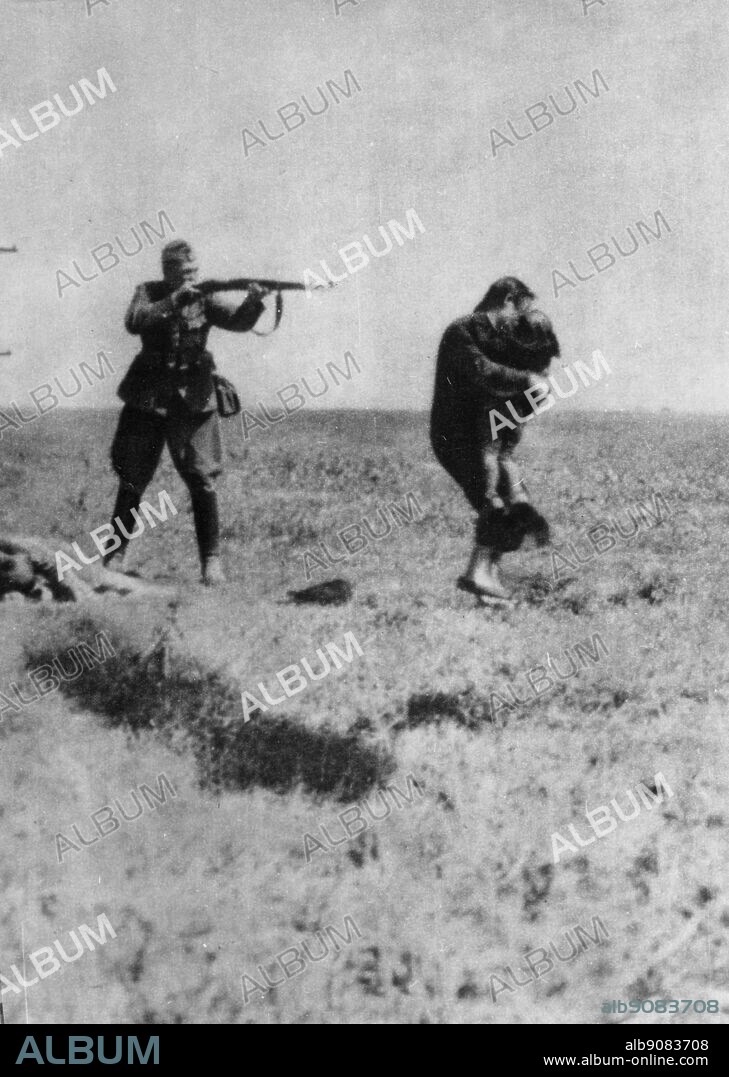 WW2: German soldier takes aim at a young mother who is carrying her child in her arms.
