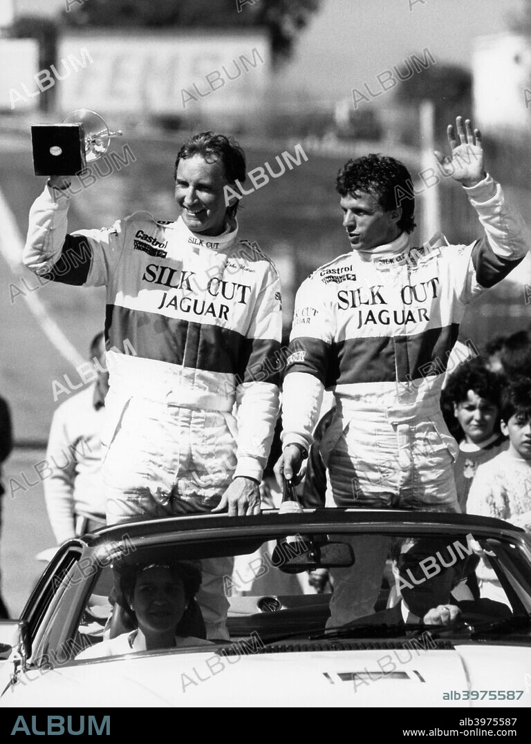 John Watson and Jan Lammers waving at the crowds at Jarama, Spain, 1987. They had won the opening round of the FIA World Sports-Prototype Championship at Jarama, driving for Jaguar in an XJR-8.