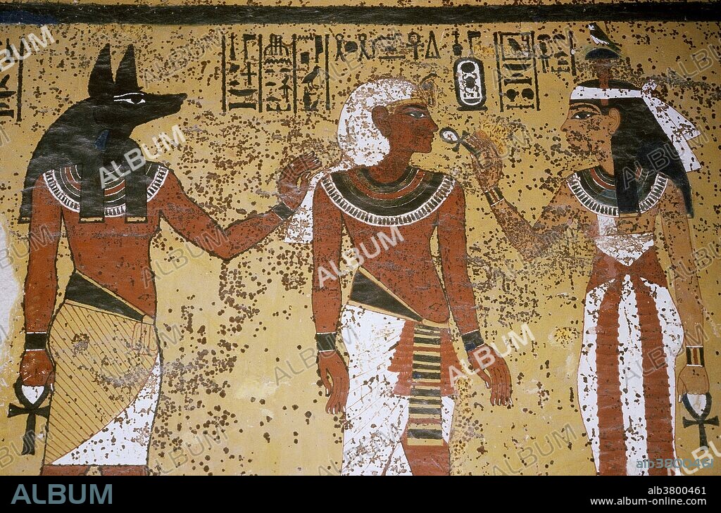 A wall painting showing the god Anubis and the goddess Isis with King Tutankhamun (1341 BCE to 1323 BCE), in the Tomb of Tutankhamun, Valley of the Kings, near Luxor, Egypt.