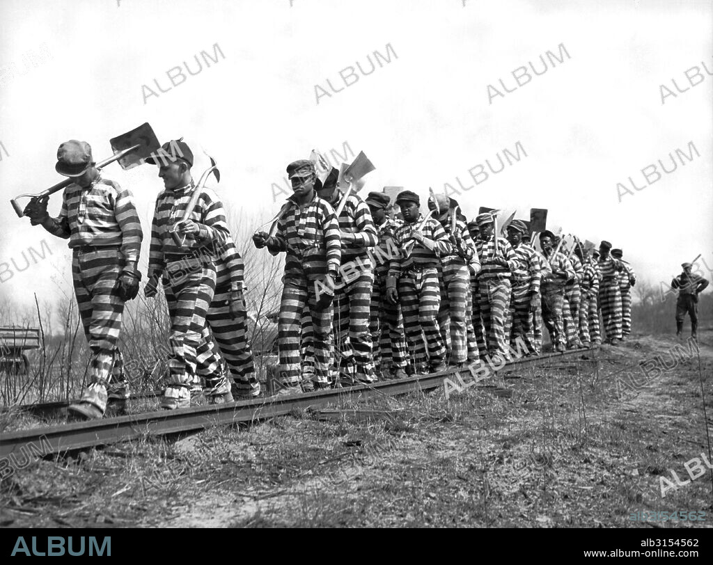 Macon, Georgia   March 8, 1937  A Bibb County chain gang with picks and shovels returns from work for the day. The county recently instituted an eight hour day for the convicts.