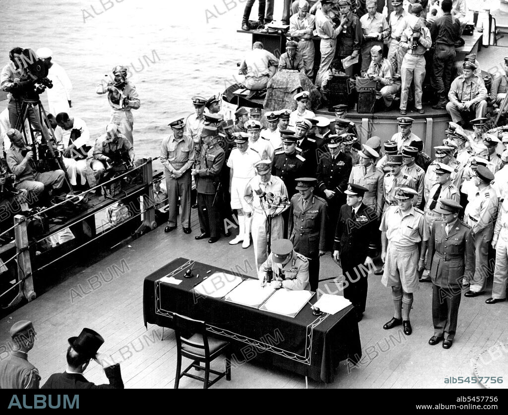 Surrender In Tokyo Bay -- General Sir Thomas Blamey on behalf of Australian signs the surrender document on board U.S.S. Missouri in Tokyo Bay in the presence of the Allied Signatories and the Japanese representatives (left foreground). August 15, 1945. (Photo by Australian Official Photo).