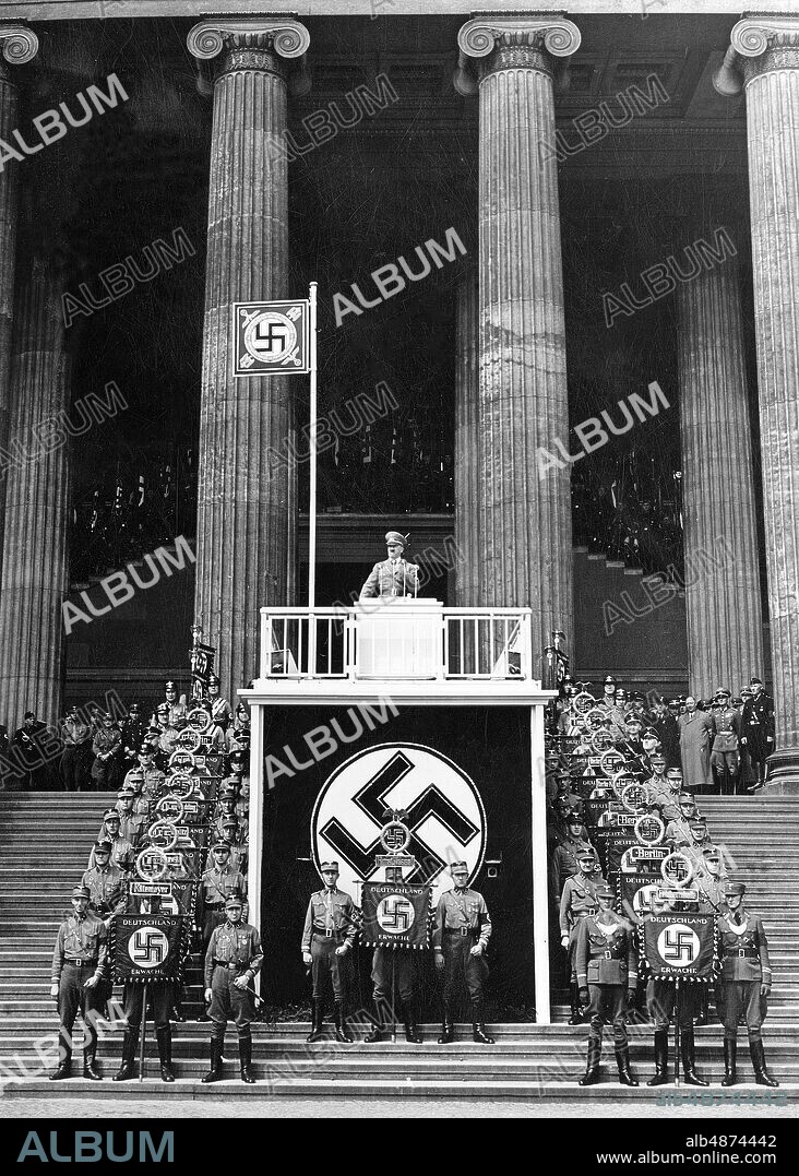GERMANY BERLIN 1938-05-01. Orig. caption ... THE 1 MAY IN THE REICHSHAUPTSTADT Our picture shows the guide during his speech at the State Act in the Berlin Lustgarten. Photo: Scherl Bilderdienst / AB Text & Bilder / SVT / Code: 5600 Folder: 1st of May in Germany 1937-39 2694 D Swastika Speaker Columns In a row Standard persons: ADOLF HITLER sites: BERLIN; GERMANY.