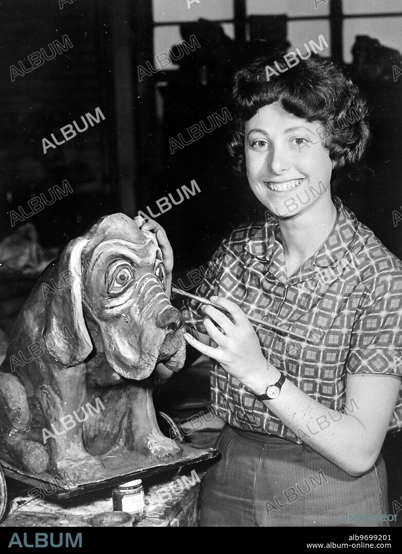 Papier Mache bloodhound gets a finishing touch of paint from Ann Beverley in readiness for a production of Midsummer Night's Dream by Shakespeare. - 23rd May 1959. ©TopFoto.