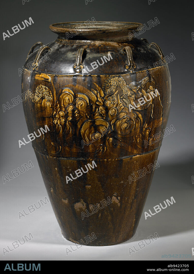 Martaban Storage Jar, early 17th century, 27 1/4 x 18 1/16 x 18 1/16 in. (69.22 x 45.88 x 45.88 cm), Stoneware with carved, appliqué and incised décor under a brown glaze, China, 17th century, Martaban jars are common stoneware storage pots named after the Arabic pronunciation of the Burmese port on the gulf of Pegu through which many of these vessels were traded. During the Ming dynasty, this busy port was under the jurisdiction of Thailand. From here Thai, Chinese, Burmese, and Cambodian goods were shipped throughout southeast Asia. These large jars were made near port towns for shipping convenience in the southern Chinese coastal provinces of Kwangtung, Fukien and Chekiang. Covered with black, brown or amber glaze, Martaban jars will typically display roughly incised decorations of dragons, clouds, pearls, or waves.